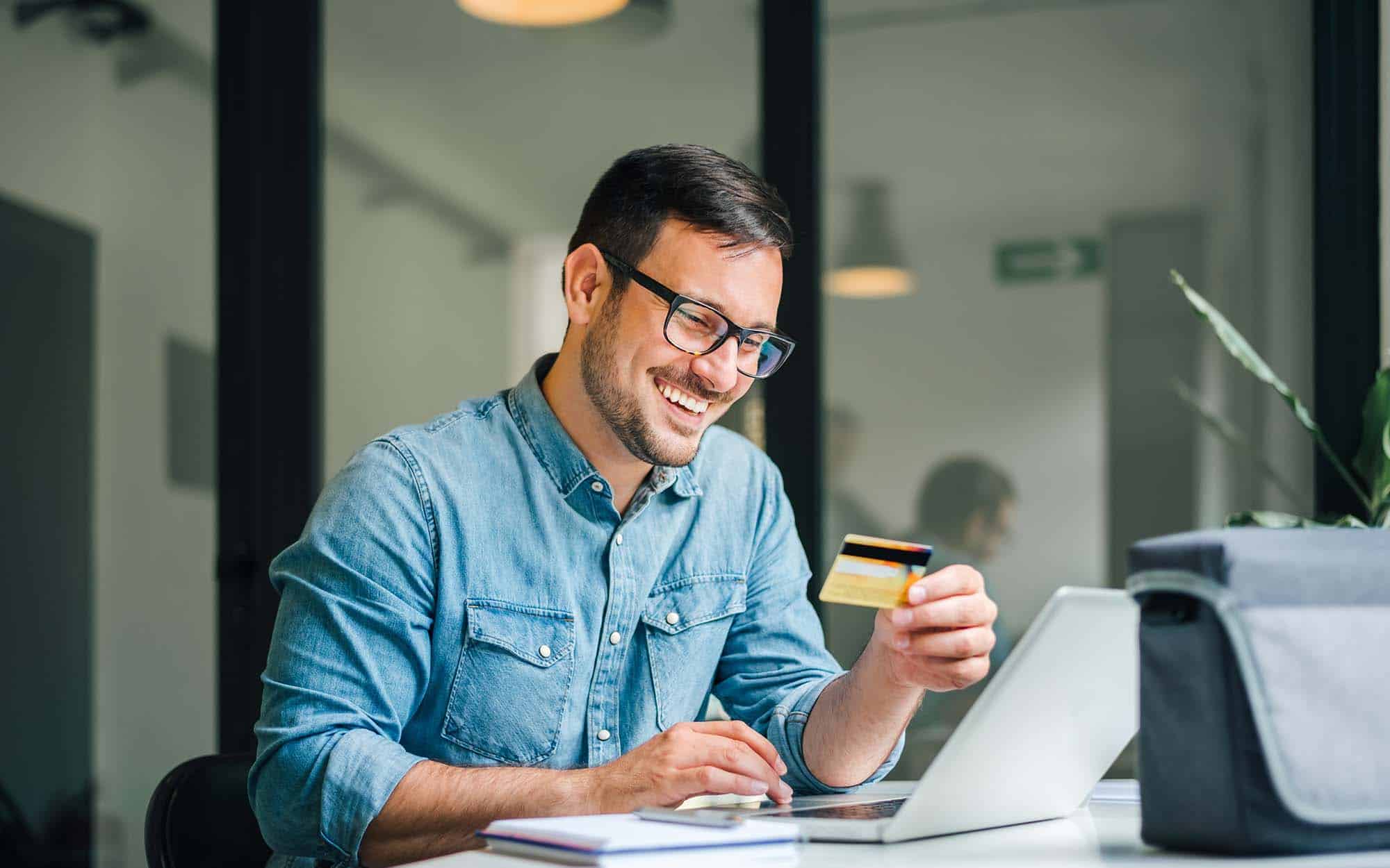 Person Making Online Payment At Laptop With Card