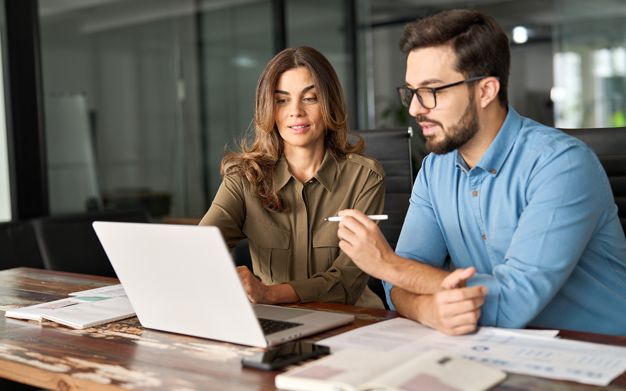 two workers looking at laptop