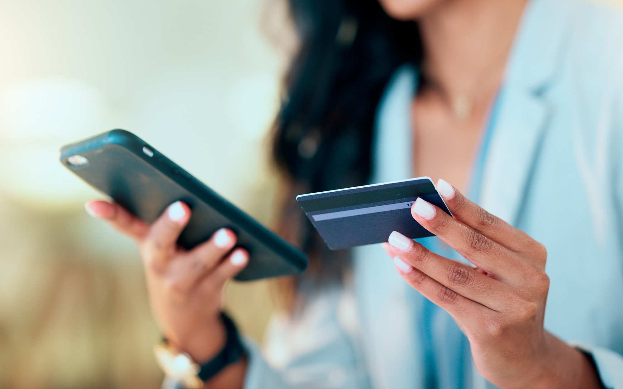 Person making payment on phone with debit card